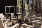 Adirondack chairs and a fire pit area in 